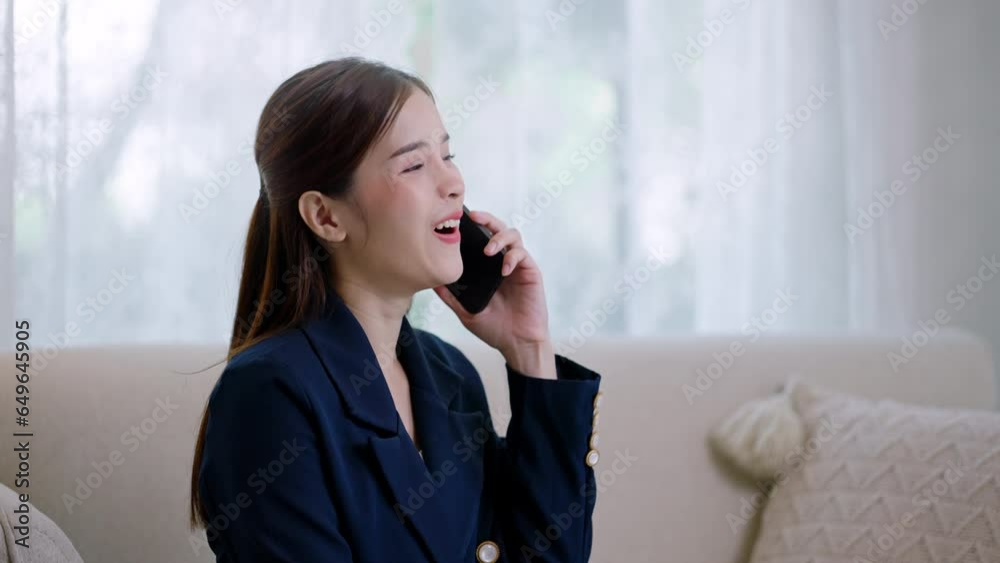Happy young asian businesswoman relax on comfortable couch at home texting messaging on smartphone,tablet,shopping online,chatting online message.asian female smiling girl use cellphone from home Happy young asian businesswoman relax on comfortable couch at home texting messaging on smartphone,tablet,shopping online,chatting online message.asian female smiling girl use cellphone from home
