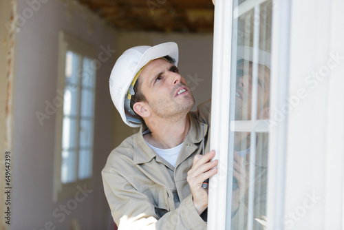 tradesman adjusting a pvc window