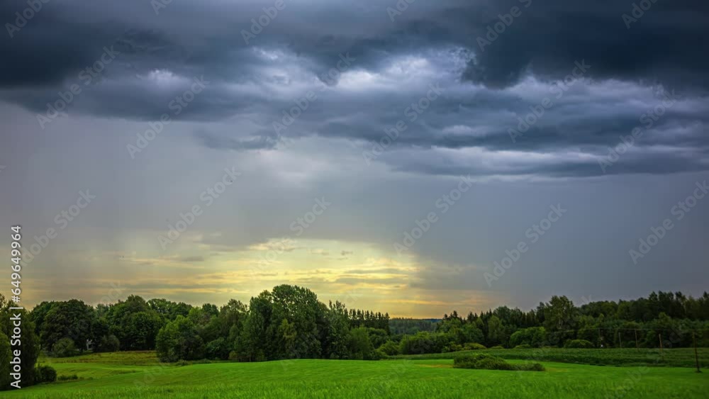 Majestic Stratonimbus Clouds and Falling Rain in Medium Wide Shot with Backlit Sunlight Majestic Stratonimbus Clouds and Falling Rain in Medium Wide Shot with Backlit Sunlight
