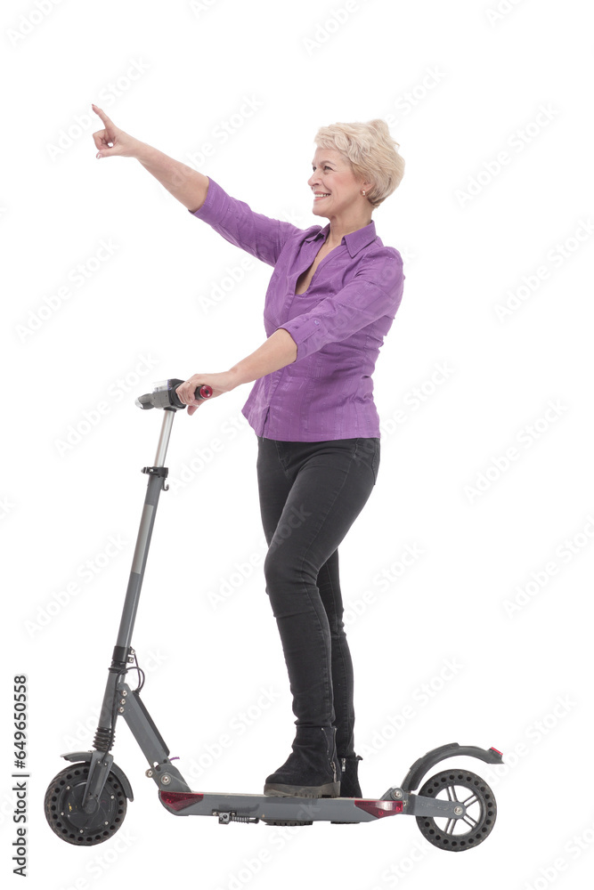 smiling mature woman with an electric scooter . smiling mature woman with an electric scooter .