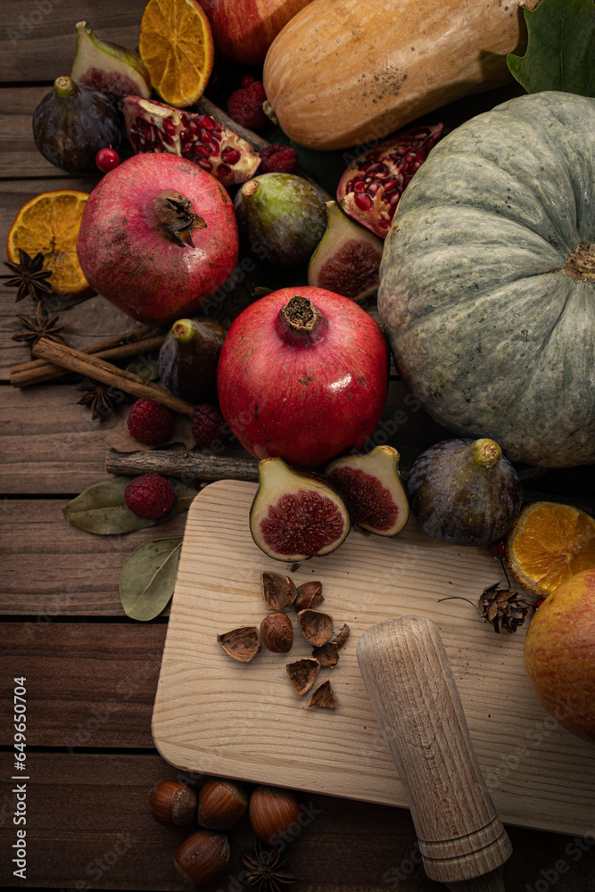 Vertical Top-Down View of Autumnal Fruits. Figs, Hazelnuts, Pomegranates, and Pumpkin Vertical Top-Down View of Autumnal Fruits. Figs, Hazelnuts, Pomegranates, and Pumpkin