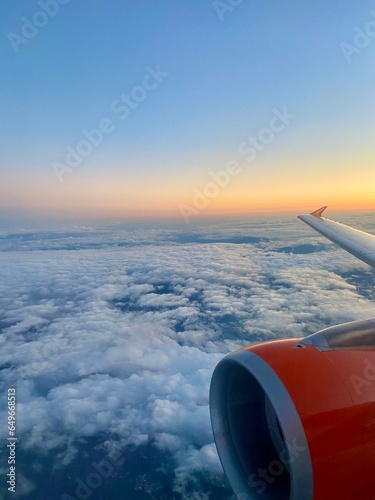 image from a plane at sunset with engine and wing in view