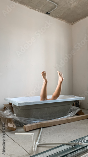 the girl's legs stick out from the bathroom. bathroom renovation photo