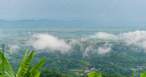 Timelapse Mountain landscape foggy winndy range mountain green landscape asian farm. Beautiful landscape mountain green field meadow white cloud blue sky on sunrise. Countryside sun light heaven photo