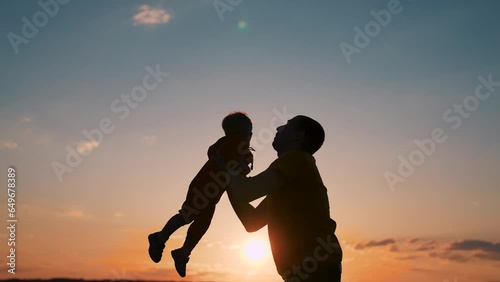 Wallpaper Mural Father, child. family spends happy moments in nature. Happy family lifestyle. father tosses laughing child up into air. parent holds child by hand. Laughing baby happy moments of life. Torontodigital.ca