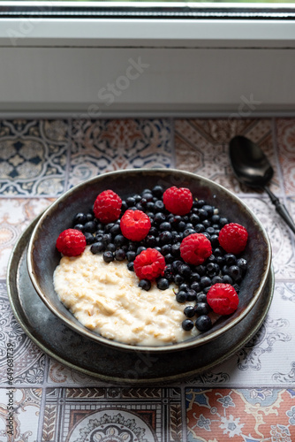 Oatmeal for breakfast with raspberries and blueberries
