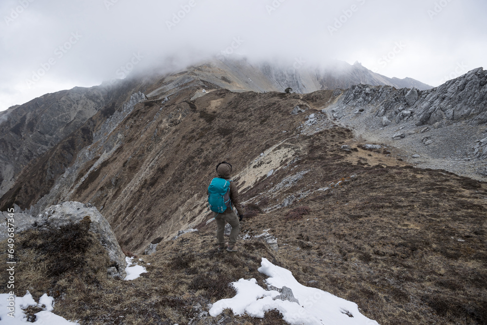 Successful woman hiker hiking at mountain top in tibet