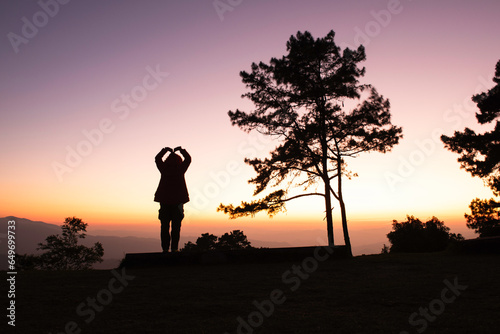 romantic silhouette of a person in the sunset