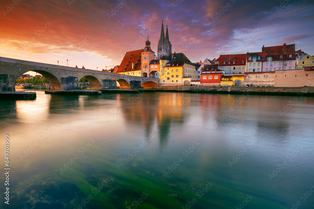 Regensburg, Germany. Cityscape image of Regensburg, Germany with Old Stone Bridge over Danube River and St. Peter Cathedral at autumn sunrise.