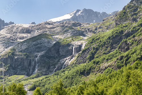 View of the valley of Sofia waterfalls with green mountain slopes  rocks and waterfalls