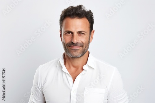 portrait of a confident Israeli man in his 40s wearing a chic cardigan against a white background