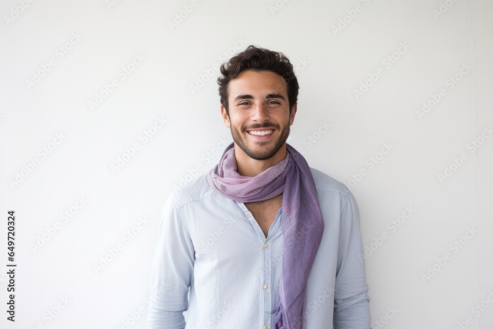 Portrait of a Israeli man in his 20s wearing a foulard against a minimalist or empty room background Portrait of a Israeli man in his 20s wearing a foulard against a minimalist or empty room background