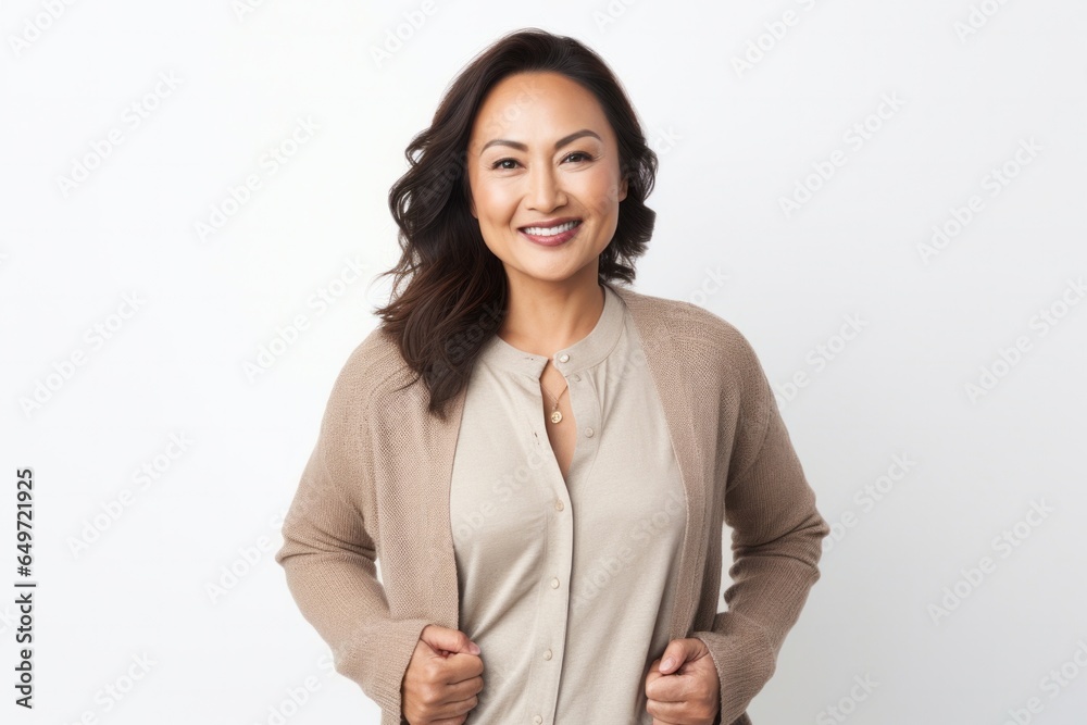 Portrait of a confident Filipino woman in her 30s wearing a chic cardigan against a white background Portrait of a confident Filipino woman in her 30s wearing a chic cardigan against a white background