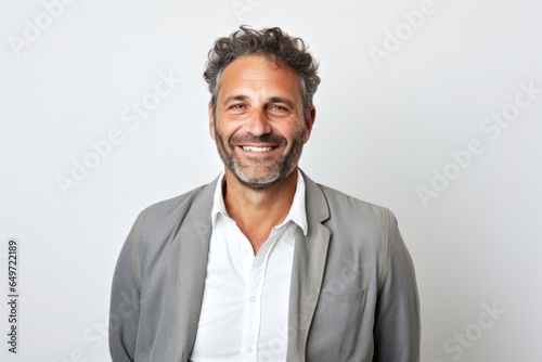 Portrait of a confident Israeli man in his 40s wearing a chic cardigan against a white background