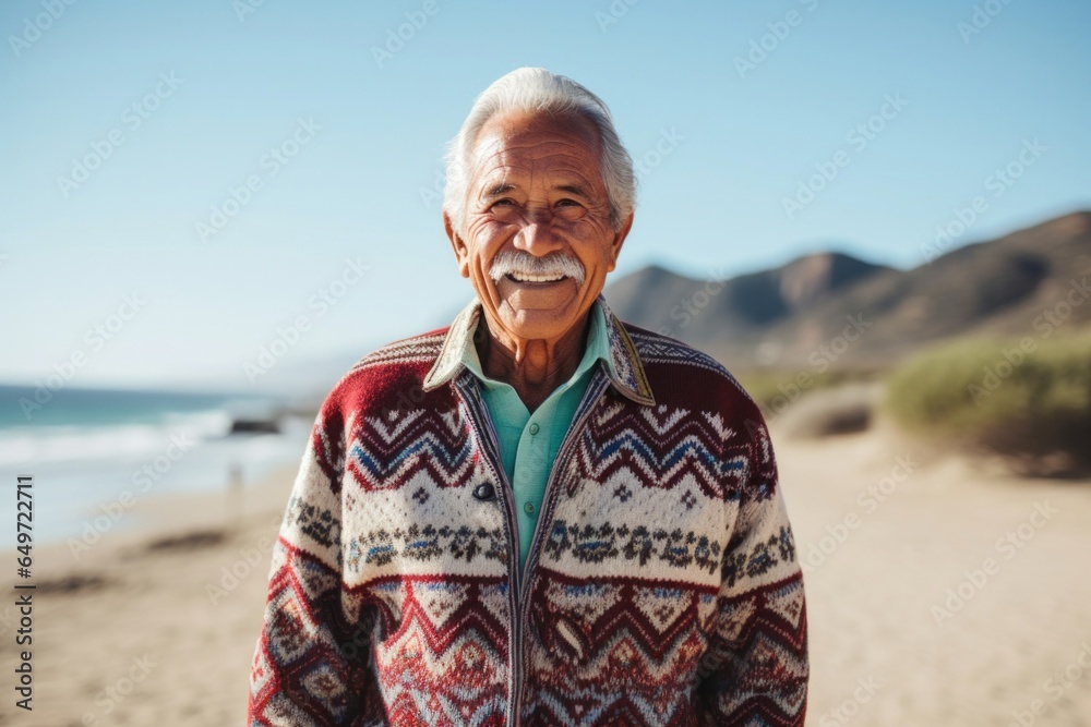 medium shot portrait of a confident Mexican man in his 80s wearing a chic cardigan against a beach background medium shot portrait of a confident Mexican man in his 80s wearing a chic cardigan against a beach background