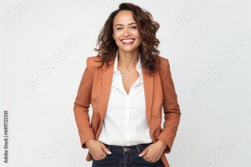 Portrait of a confident Mexican woman in her 40s wearing a classic blazer against a white background