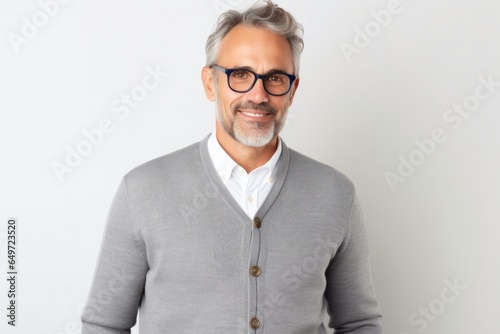 Portrait of a confident Polish man in his 40s wearing a chic cardigan against a white background