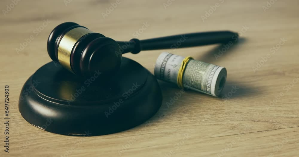 Judge gavel, money and cash bribe on a table for auction, corruption and court expense. Dollar bill, finance and hammer for laundering, currency or law attorney for fraud, debt or government earnings Judge gavel, money and cash bribe on a table for auction, corruption and court expense. Dollar bill, finance and hammer for laundering, currency or law attorney for fraud, debt or government earnings