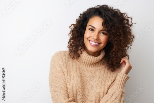 medium shot portrait of a Mexican woman in her 30s wearing a cozy sweater against a white background