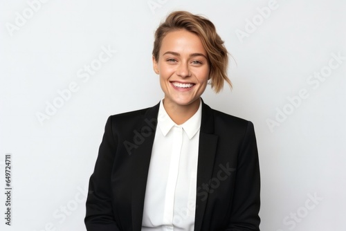 medium shot portrait of a happy Polish woman in her 30s wearing a sleek suit against a white background