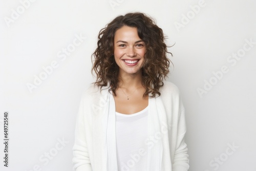portrait of a happy Polish woman in her 30s wearing a chic cardigan against a white background