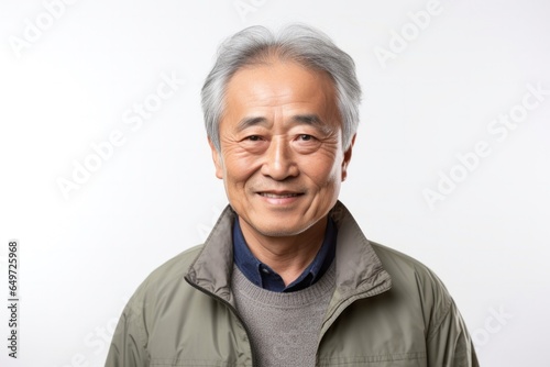 medium shot portrait of a happy Japanese man in his 60s wearing a chic cardigan against a white background