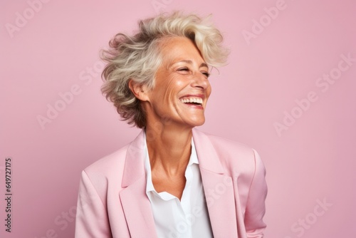 portrait of a happy Israeli woman in her 50s wearing a classic blazer against a pastel or soft colors background