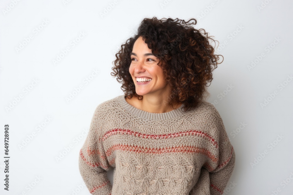 portrait of a happy Mexican woman in her 40s wearing a cozy sweater against a white background portrait of a happy Mexican woman in her 40s wearing a cozy sweater against a white background