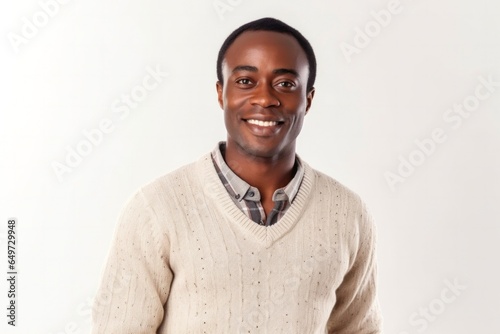 medium shot portrait of a Kenyan man in his 30s wearing a chic cardigan against a white background © Anne-Marie Albrecht