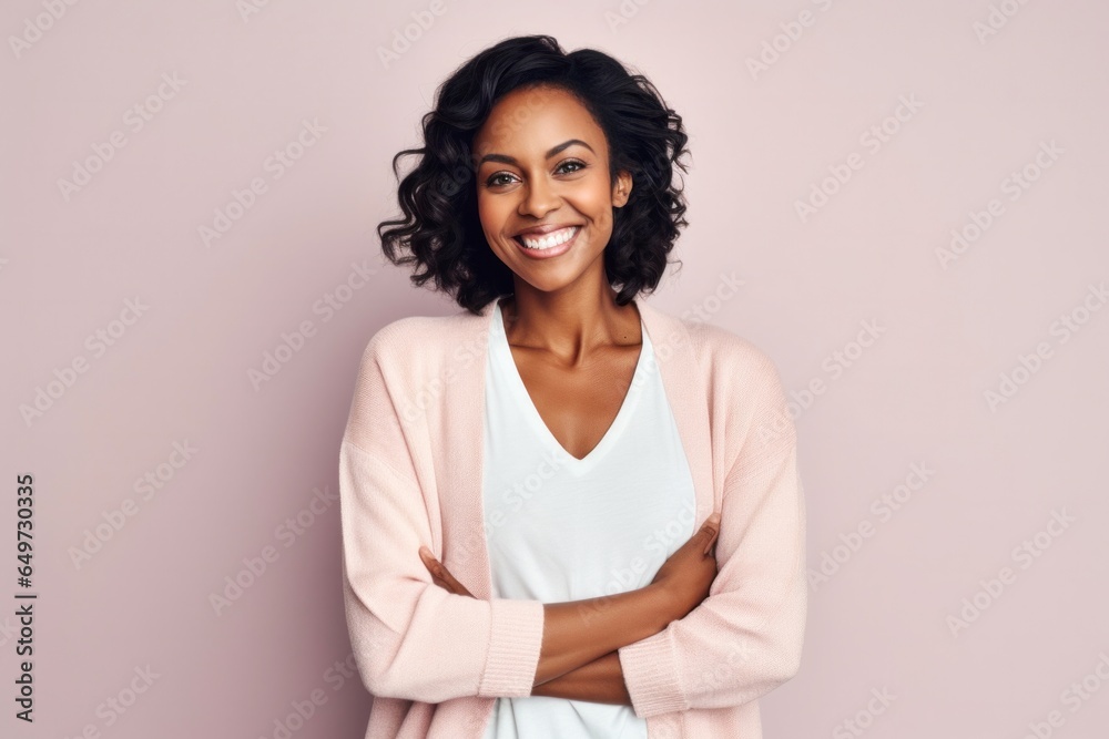 Fototapeta premium medium shot portrait of a Kenyan woman in her 30s wearing a chic cardigan against a pastel or soft colors background