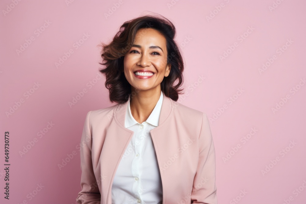 portrait of a Filipino woman in her 50s wearing a chic cardigan against a pastel or soft colors background