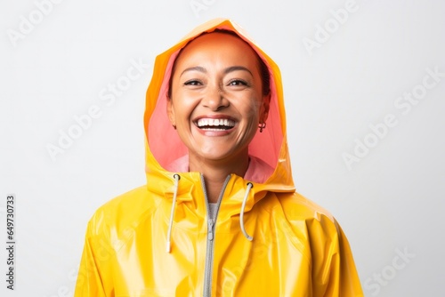 portrait of a Filipino woman in her 40s wearing a vibrant raincoat against a white background photo