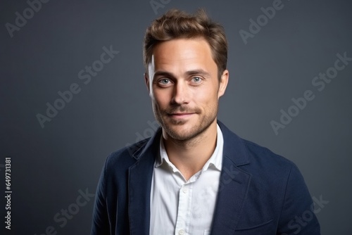 medium shot portrait of a Polish man in his 30s wearing a chic cardigan against a white background