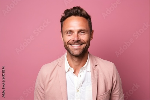 medium shot portrait of a Polish man in his 30s wearing a chic cardigan against a pastel or soft colors background © Anne-Marie Albrecht