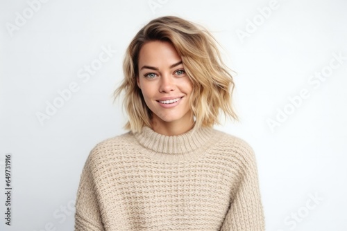 medium shot portrait of a Polish woman in her 30s wearing a cozy sweater against a white background