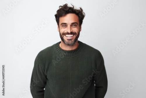 medium shot portrait of a confident Israeli man in his 30s wearing a cozy sweater against a white background