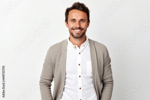 portrait of a Polish man in his 30s wearing a chic cardigan against a white background