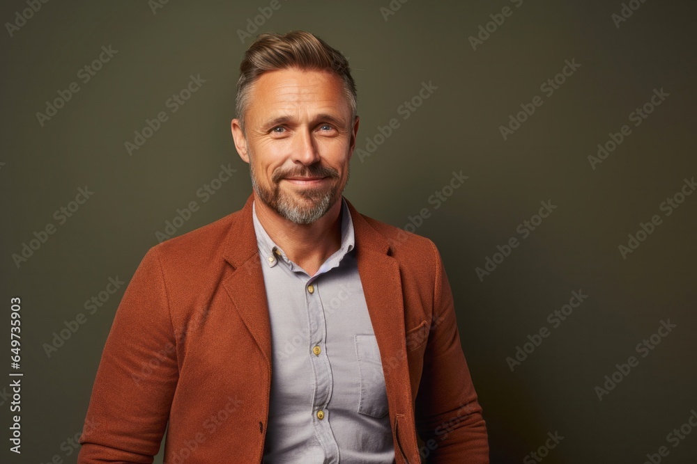 portrait of a Polish man in his 40s wearing a chic cardigan against an abstract background portrait of a Polish man in his 40s wearing a chic cardigan against an abstract background