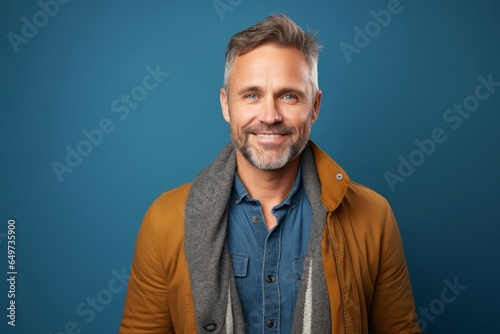portrait of a Polish man in his 40s wearing a chic cardigan against an abstract background