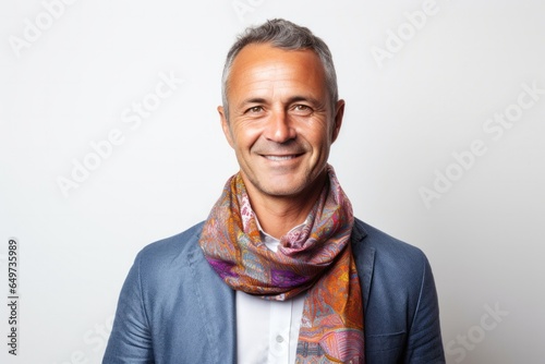 portrait of a Polish man in his 40s wearing a foulard against a white background