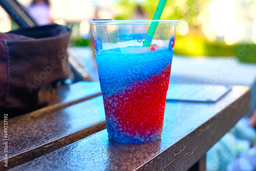 Tableau sur toile Having a slush puppy drink outside.
