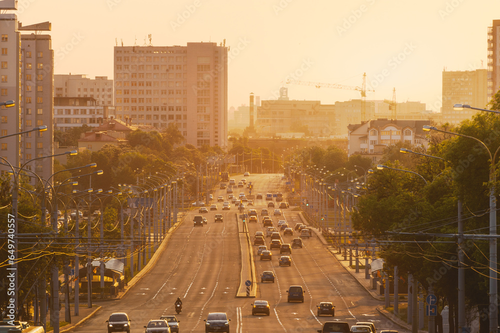 An avenue of the city on sunset in summer - obrazy, fototapety, plakaty 