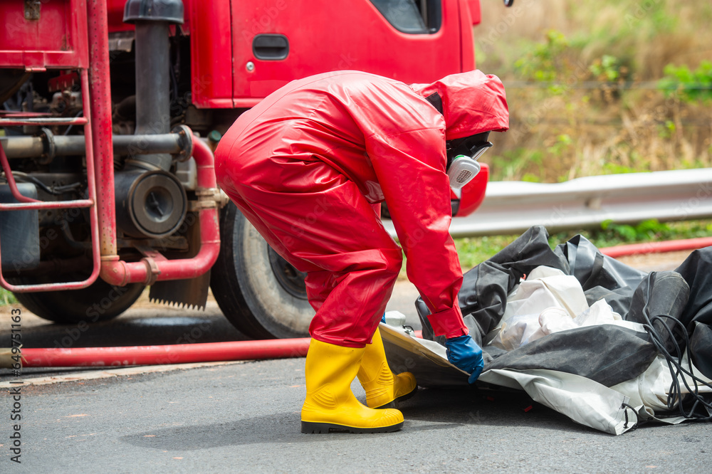 Rescuers wearing red hazmat suits assembled a Inflatable sterilization ...