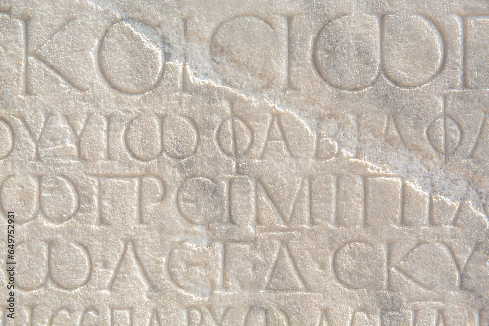 Historical inscription. Fragment of ancient law (imperial edict at Ancient Greek language), carved on marble block. Ancient art and history concept. Retro text background. Kayseri, Turkey (Turkiye)