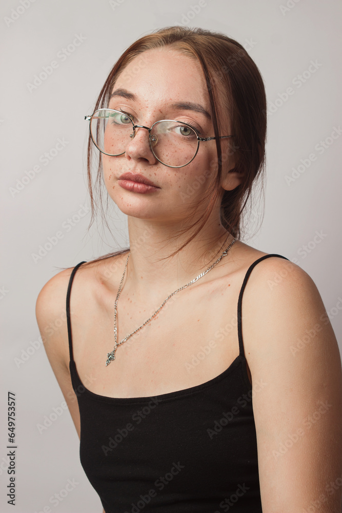 Portrait of a girl with glasses on a white background