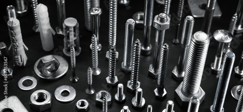 Tableau sur toile various metal screws, bolts and fasteners on black background