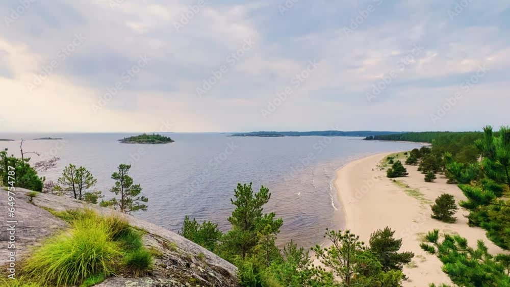 Russia, Karelia, Lake Ladoga, Koyonsaari. View of the sandy coast of the island in a cold lake. Stunning panoramic view of the Ladoga Skerry Islands. Northern sandy beach with an area of 4 km. 4K Russia, Karelia, Lake Ladoga, Koyonsaari. View of the sandy coast of the island in a cold lake. Stunning panoramic view of the Ladoga Skerry Islands. Northern sandy beach with an area of 4 km. 4K