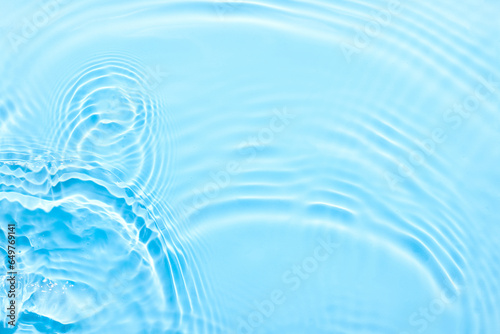 Water blue surface abstract background. Waves and ripples texture of cosmetic aqua moisturizer with bubbles