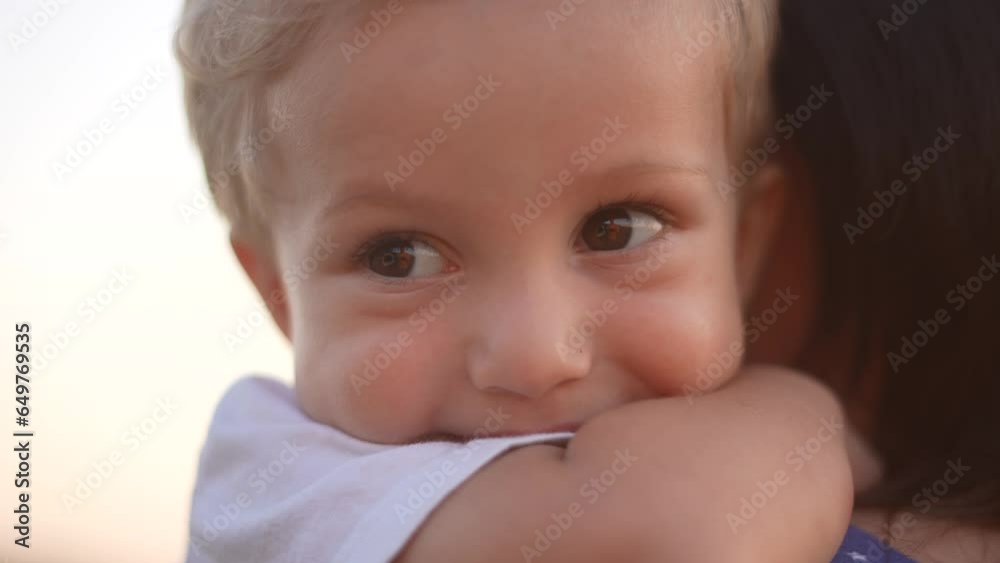 mother holding her son in her arms in the park. baby son hugs mom big in the park in nature. happy family kid dream concept. mom take care of her son baby sun hugs him holds him in her arms in park mother holding her son in her arms in the park. baby son hugs mom big in the park in nature. happy family kid dream concept. mom take care of her son baby sun hugs him holds him in her arms in park