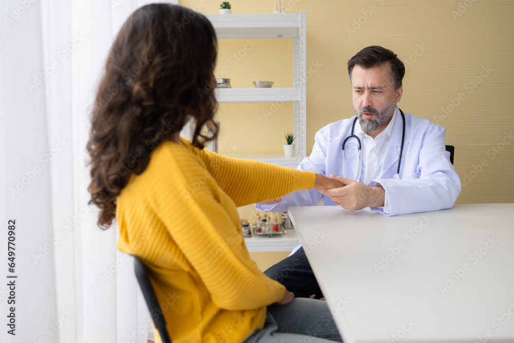 Doctor examining the patient's arm and upper arm in doctor's room. Medical and healthcare concept. Doctor examining the patient's arm and upper arm in doctor's room. Medical and healthcare concept.